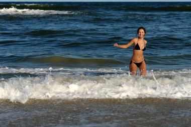 Young woman on the beach clipart