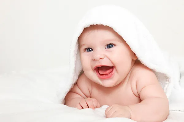 Laughing baby with towel — Stock Photo, Image