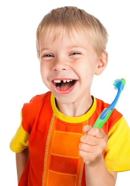 Αριστερόχειρας γελαστό αγόρι με οδοντόβουρτσα — Φωτογραφία Αρχείου