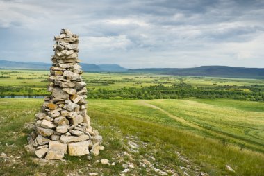 Stone cairn in Khakassia clipart