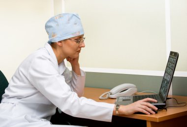 Female doctor with laptop clipart