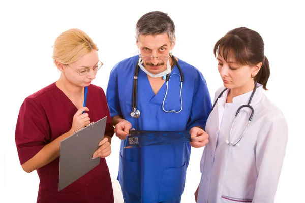 Suspicious doctor with his team — Stock Photo, Image