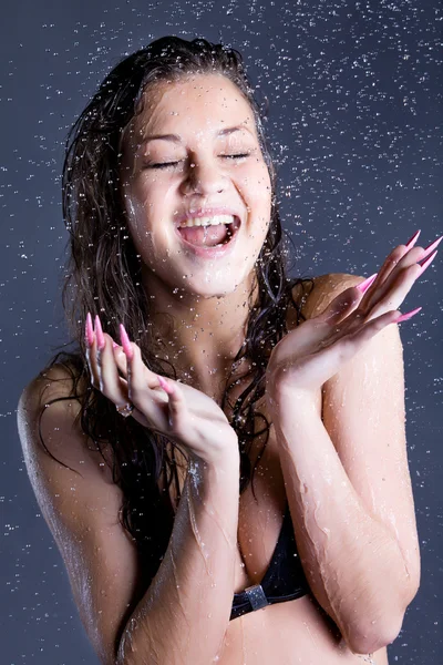 Mujer joven disfrutar en gotitas de agua — Foto de Stock