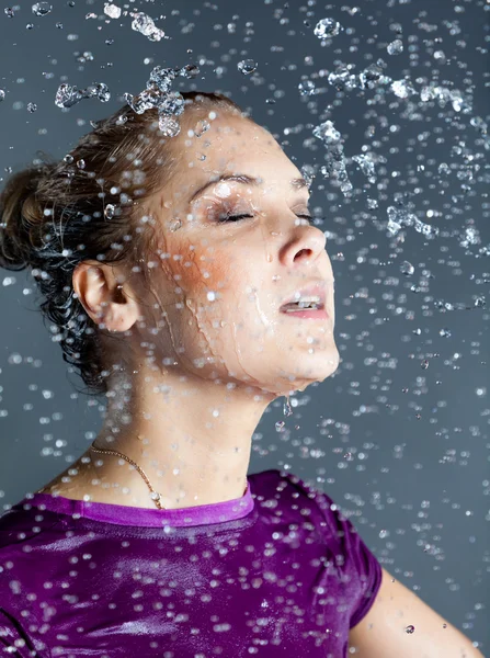 stock image Young woman in water splashes and droplets