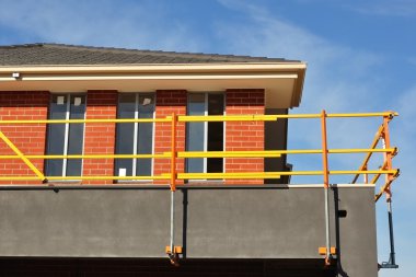 Bright scaffolds on new house clipart