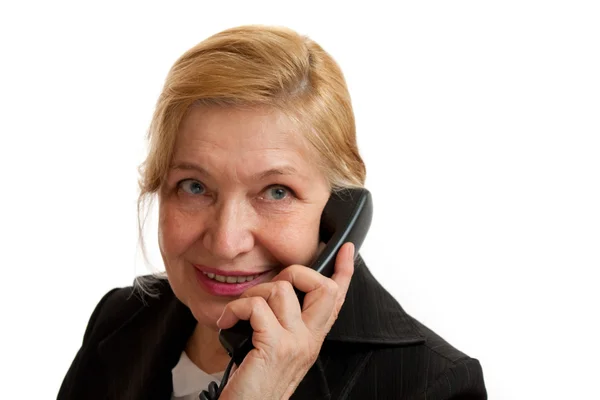 stock image Senior Woman talking on the phone in black suite on white backgr