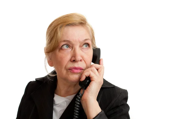 stock image Senior Woman talking on the phone in black suite on white backgr