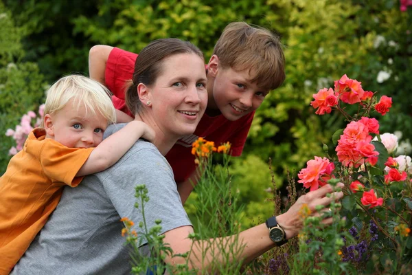 Mother with children in the garden — Stock Photo, Image