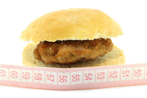 Pequeno pão com costeleta e régua de medida de metro — Fotografia de Stock