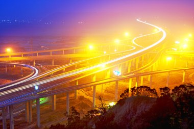 Traffic track on highway in the night clipart