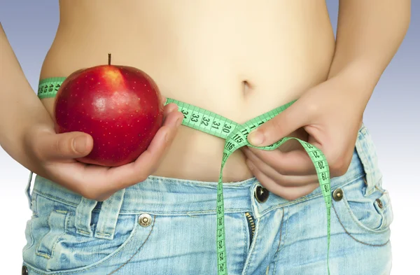 Mulher com maçã vermelha e fita métrica — Fotografia de Stock
