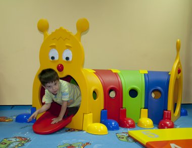 Little boy in the indoor playground clipart