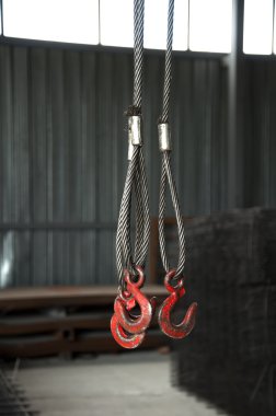 Three metal hooks with wire rope clipart