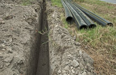 Plastic pipes in a ditch clipart