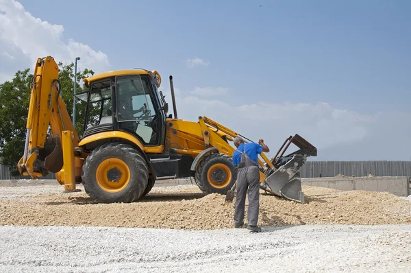 stock image Worker and gravel excavator