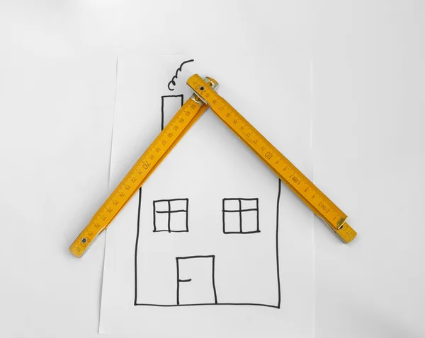 Drawed dom i drewniane miernik — Zdjęcie stockowe