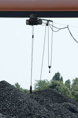 Crane and piles of coal clipart