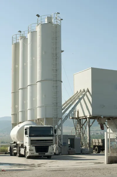 Cementfabrik och en lastbil som laddar cement — Stockfoto