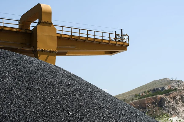 Asphalt pile and crane in quarry — Stock Photo, Image