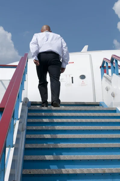 Businessman who climbs on plane — Stock Photo, Image