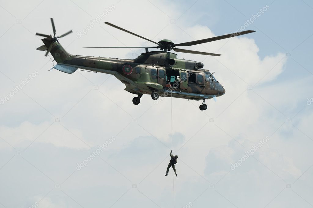 depositphotos_6643209-stock-photo-soldier-hanging-from-a-helicopter.jpg