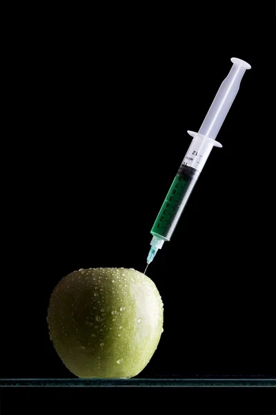Syringes stuck in an apple — Stock Photo, Image