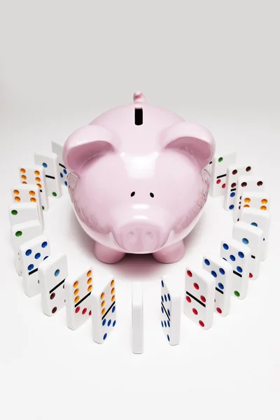 Piggy bank and dominoes — Stock Photo, Image