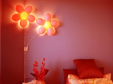 Vibrant red bedroom with pink flower lights clipart