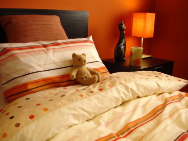 Orange bedroom with teddy bear clipart