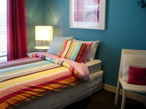 Vibrant blue and multi coloured bedroom — Stock Photo, Image