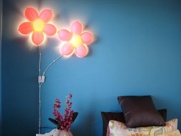 핑크 꽃 빛으로 활기찬 블루 침실 스톡 이미지