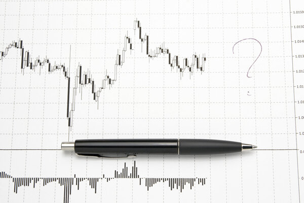 Printed forex chart with pen - uncertainty of future