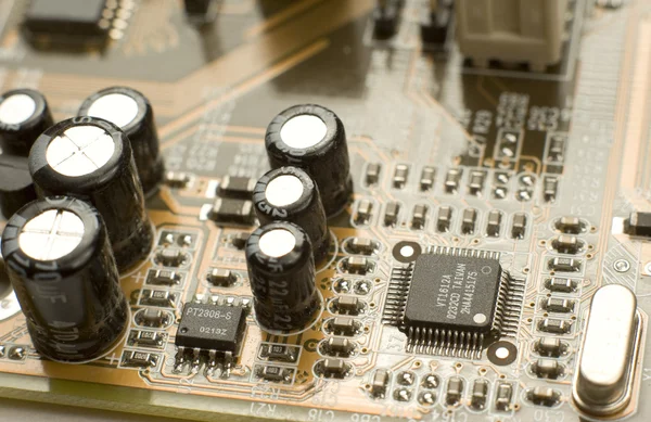 Capacitors and microchips on circuit board — Stock Photo, Image
