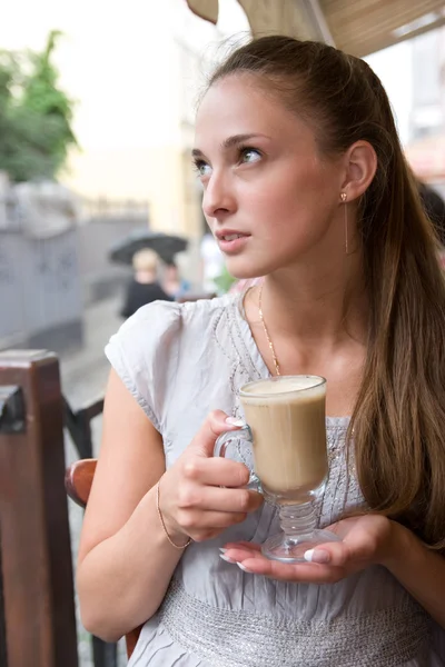 Woman is holding cappuccino — Stock Photo, Image