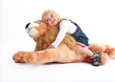 Girl leaning on a toy lion clipart