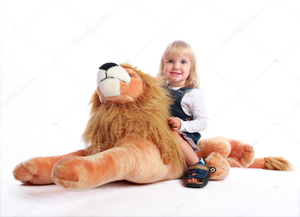 Little girl riding a toy lion