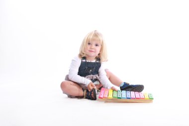 Girl playing a musical toy clipart