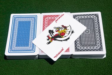 Joker over three decks of cards clipart