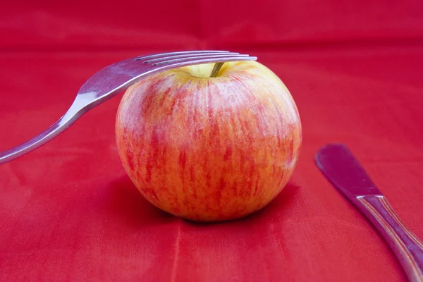 Golden-red apple on red — Stock Photo, Image