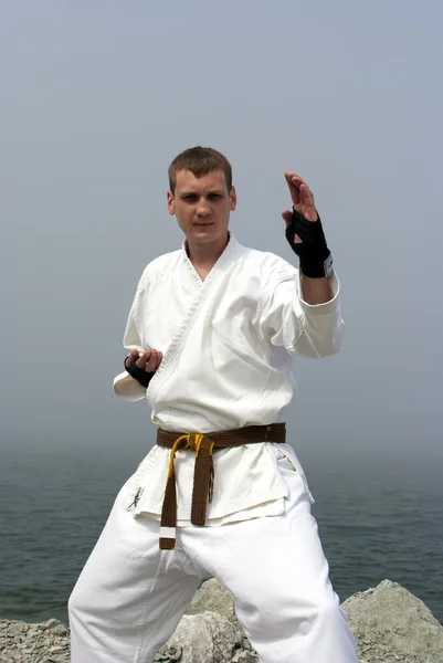 Karate on the shores of the misty sea — Stock Photo, Image
