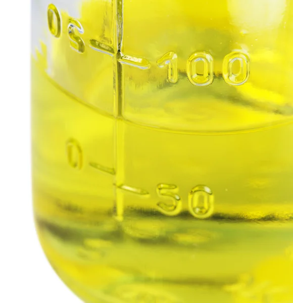 Glass jar with a yellow liquid — Stock Photo, Image