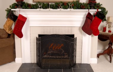 White fireplace decorated for Christmas clipart