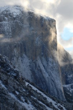 El Capitan illuminated by early morning stormy skies clipart