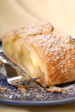 Fresh apple strudel with powdered sugar clipart