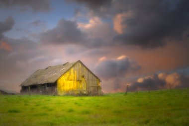 Old barn under dark skies with soft focus clipart