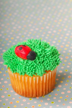 Cupcake decorated with grass frosting clipart