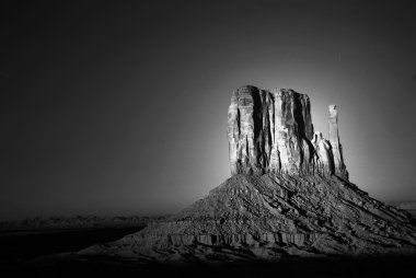 Dramatic light of dawn striking a rock formation in Monument Val clipart