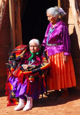 Very old Navajo woman with her daughter clipart