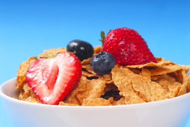 Bran cereal with blueberries, strawberries clipart