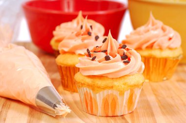 Halloween cupcakes being frosted clipart